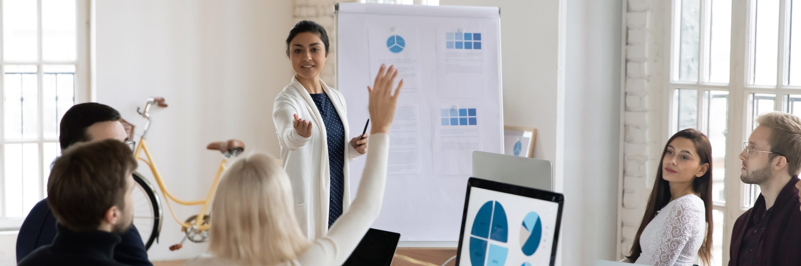 Presentation skills training being applied with confidence in a meeting