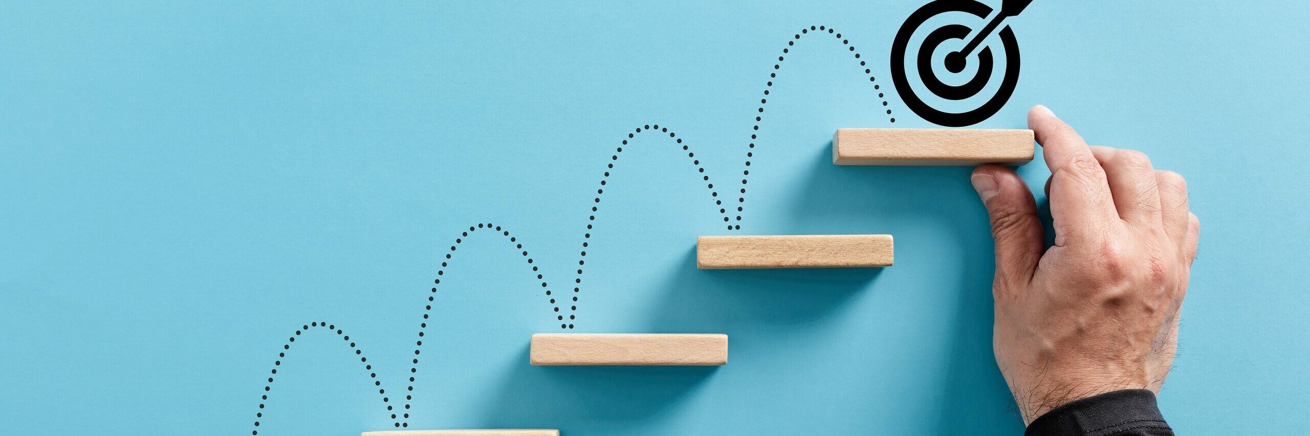 Man places building blocks setting objectives