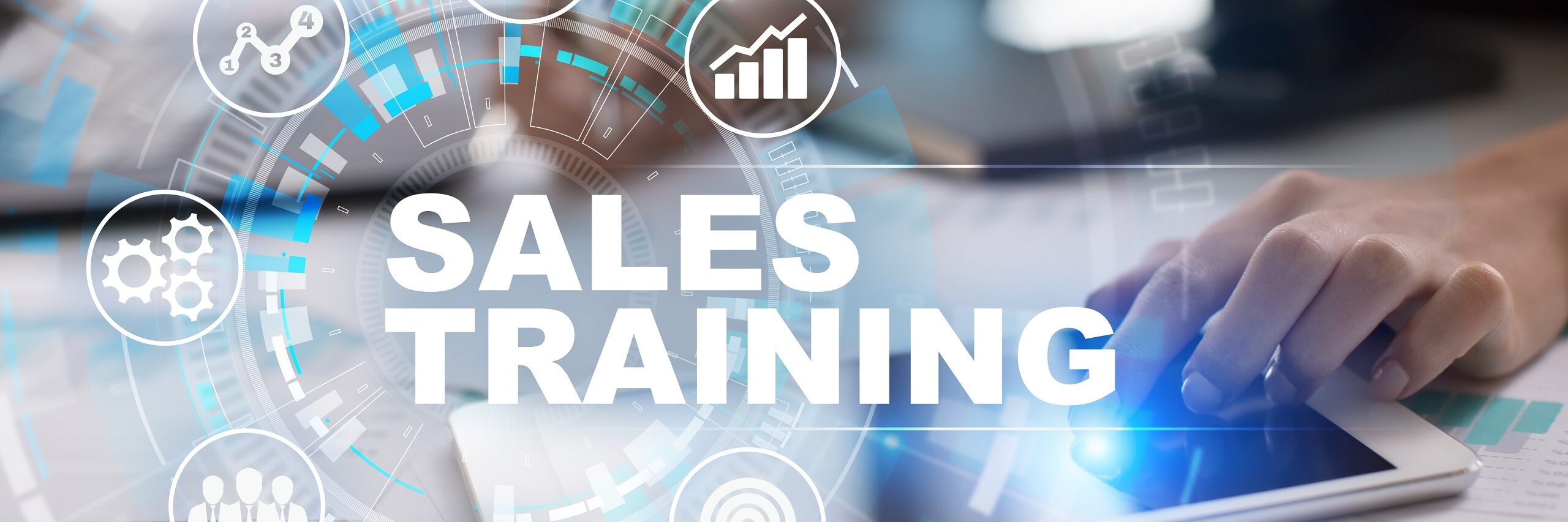 Person at a desk with a graphic that says Sales Training Program